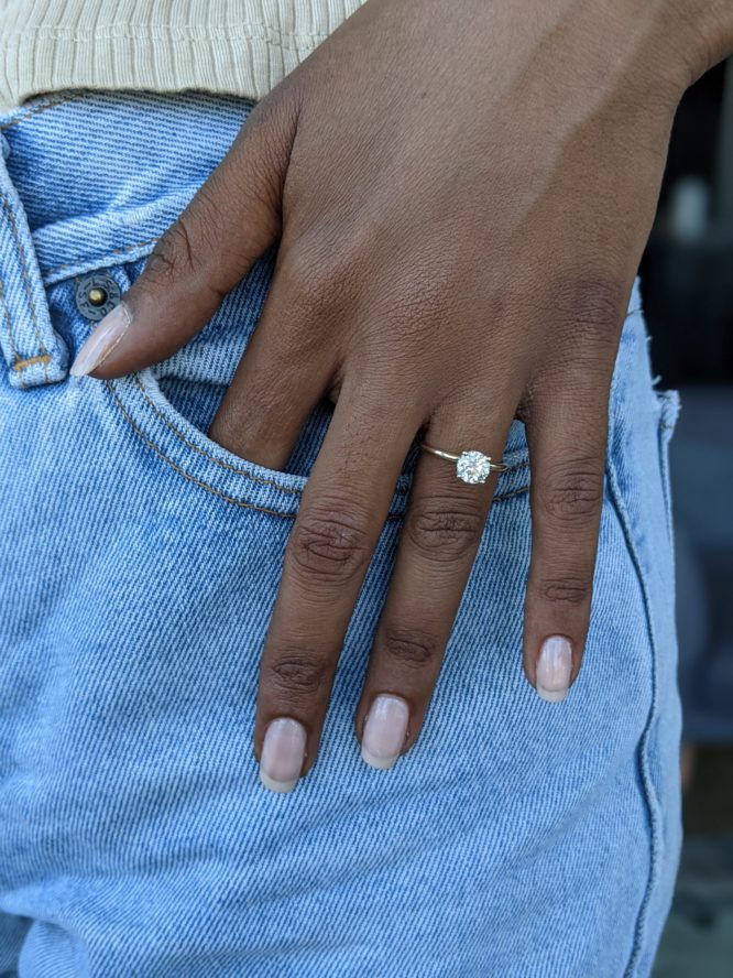 Mia ring - 1.1 carat round diamond ring on a finger