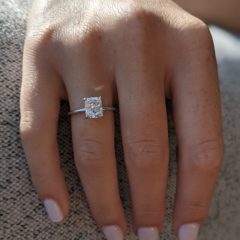 Bella ring - 1.14 carat cushion cut diamond ring on a finger