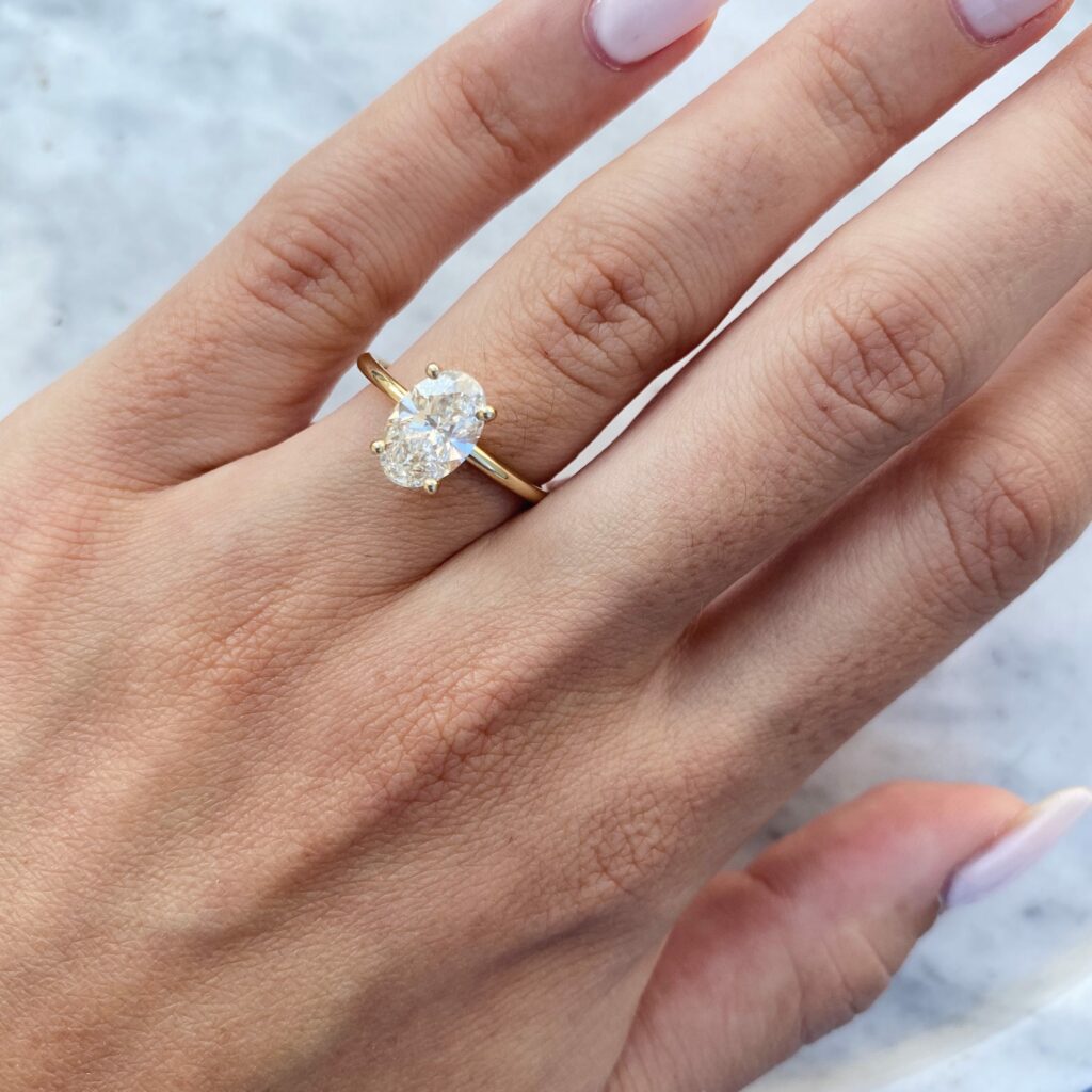 Adi ring - 1.52 carat oval cut diamond ring on a finger