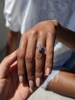 Charlotte emerald cut diamond ring worn on a finger