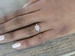 Camila diamond engagement ring worn on a finger