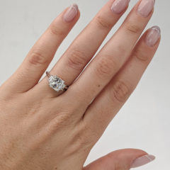 Penelope cushion cut diamond ring worn on a finger